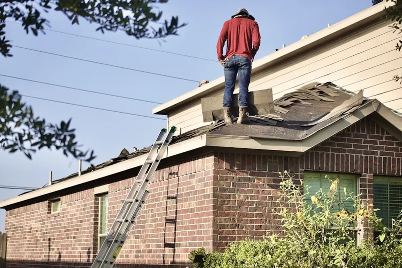 Professional roofer working on a residential roof in Centura West
